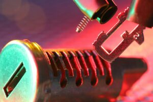 Macro shot of a mechanical lock cylinder and key, highlighting detailed components under vibrant lighting.